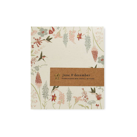 Off white notepad with images of various flowers and hummingbirds around the border.