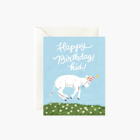 Blue card with white text saying, “Happy Birthday, Kid!” Image of a white goat wearing a birthday party hat jumping over a patch of green grass. A white envelope is included.