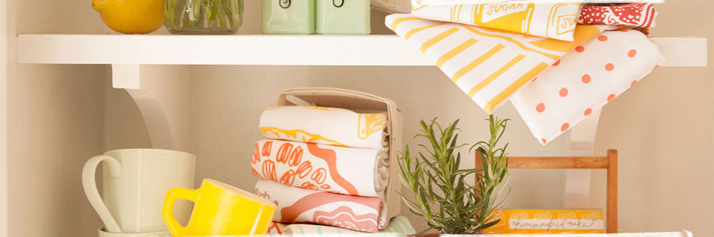 tea towels and mugs on shelves