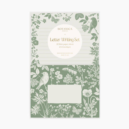 Ivory lined paper with images of green leaves, butterfly, bird and flowers around border. Green envelopes with ivory images of bird, flowers and butterfly.