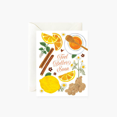 White card with red text saying, “Feel Better Soon”. Images of a lemon, lemon slices, honey, ginger, and cinnamon sticks. A white envelope is included.