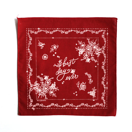 Square with red background and white text saying, “Best Day Ever”. Images of white flowers and white floral border.