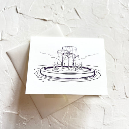 Ivory card with black ink with image of fountain from TCU. An ivory envelope is included.