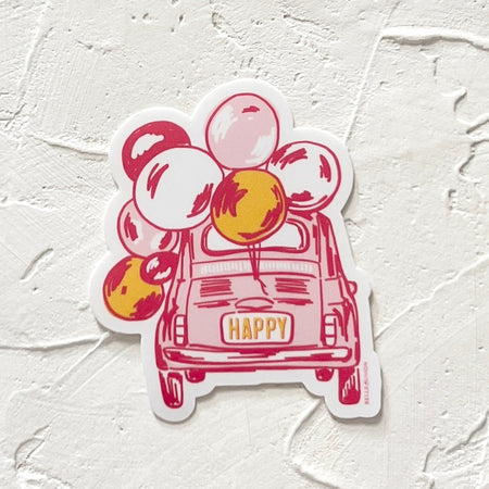 White sticker with image of pink and red vintage beetle bug car with “HAPPY” in yellow text on license plate. White, yellow and pink balloons attached to car.