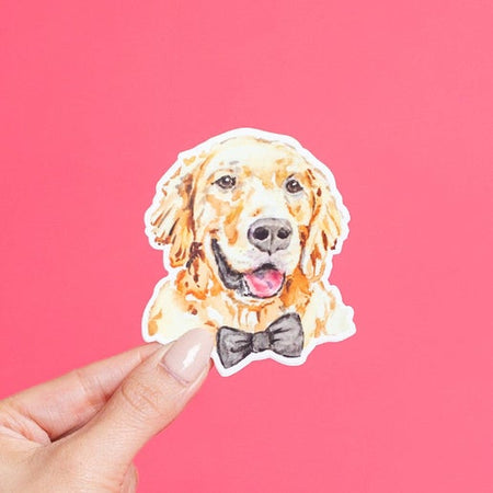 Sticker with an image of a Golden Retriever dog head with its tongue sticking out and wearing a black bow tie.