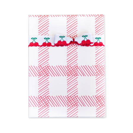 White and red checked paper in the pattern of a classic picnic blanket.