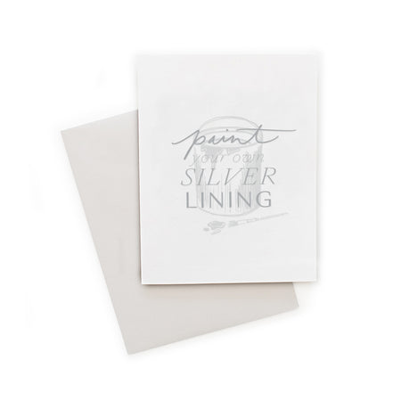 White card with gray text saying, “Paint Your Own Silver Lining”. Image of a paint can with gray paint spilling out and a paintbrush. A gray envelope is included.