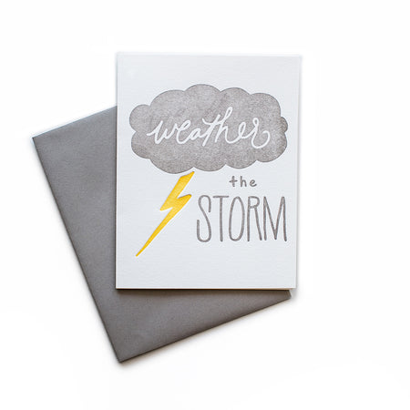 White card with gray and yellow text saying, “Weather the Storm”. Images of a gray rain cloud and yellow lightning bolt. A gray envelope is included.
