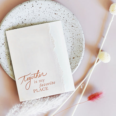 Ivory and white card with curved torn edging where two colors meet. Red text saying, “Together Is My Favorite Place”. A white envelope is included.