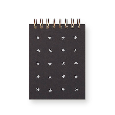 Black cover with silver foil stars in a grid pattern. Metal spiral coil binding across the top.