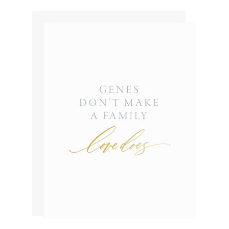 White card with gray and gold text saying, “Genes Don’t Make a Family Love Does”. A gray envelope is included.