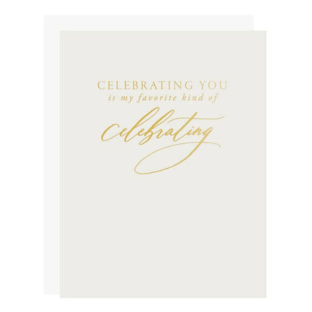 Off white card with gold text saying, “Celebrating you is my favorite kind of celebrating”. A white envelope is included.
