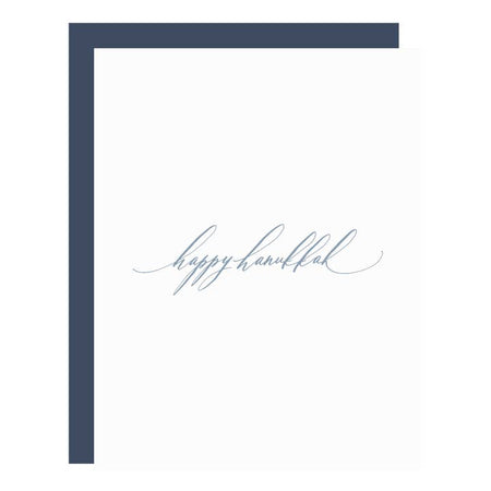 White card with gray text saying, “Happy Hanukkah”. A navy blue envelope is included.