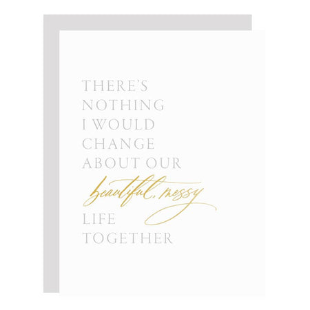 White card with gray and gold text saying, “There’s nothing I would change about our beautiful messy lie together”. A gray envelope is included.