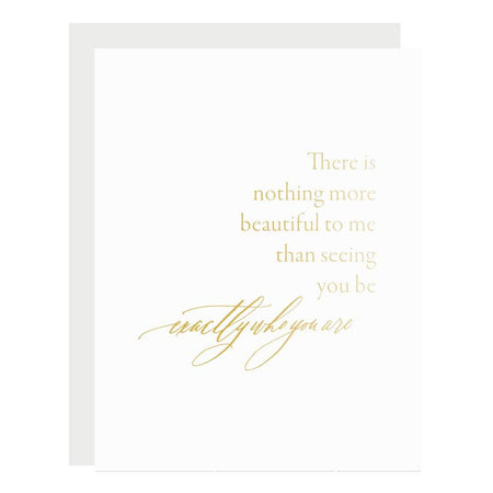 White card with gold text saying, “There is nothing more beautiful to me than seeing you be exactly who you are”. A gray envelope is included.