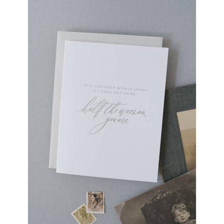 White card with gray text saying, “I will consider myself lucky if I turn out to be half the woman you are”. A gray envelope is included.