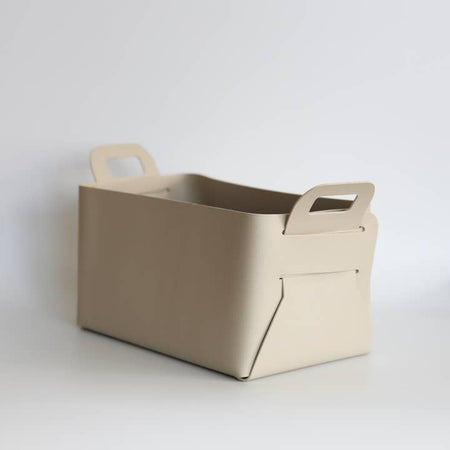 Dark cream colored leather soft sided box with handles.