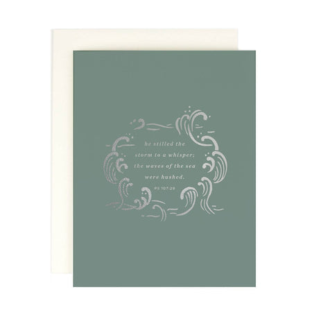 Green card with silver foil accent text saying, “He still the storm to a whisper; the waves of the sea were hushed. Psalm 107:29”. Silver foil waves image. An ivory envelope is included.