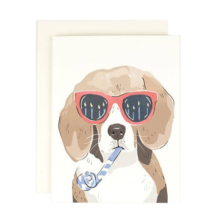Ivory card with image of a beagle dog wearing red sunglasses and blowing a blue party horn. An ivory envelope is included.