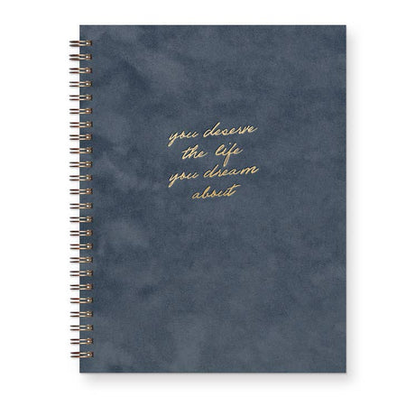 Notebook with midnight blue suede cover with gold foil text saying, 