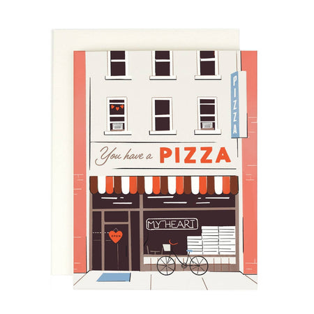 Ivory card with image of a city building block with a pizza place. Windows above and a red and white awning saying, “You Have a Pizza My Heart”. An ivory envelope is included.