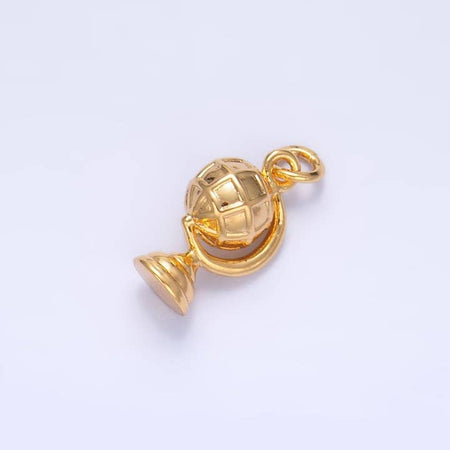 Gold charm in the image of a globe.