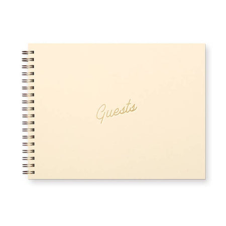 Notebook with ivory cover and gold foil text saying, 