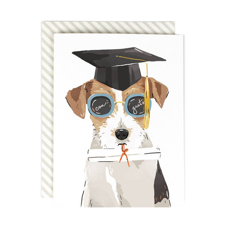 Ivory card with image of a beagle dog wearing a black graduation hat and holding a diploma in its mouth; wearing blue sunglasses that say, “Congrats!”. An ivory envelope is included.
