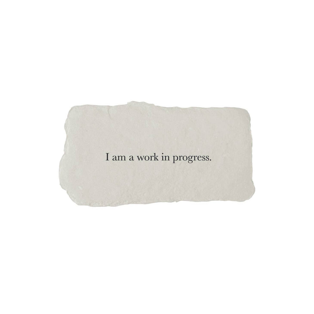 Gray rectangle with torn edges and black text saying, “I am a Work in Progress”.