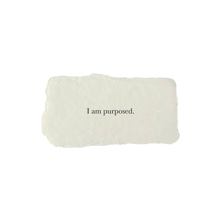 Gray rectangle with torn edges and black text saying, “I am Purposed”.