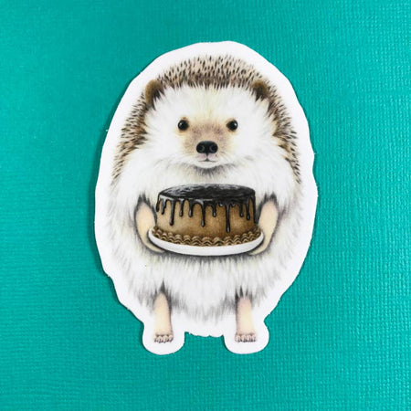 Sticker with images of a hedgehog holding a chocolate cake.