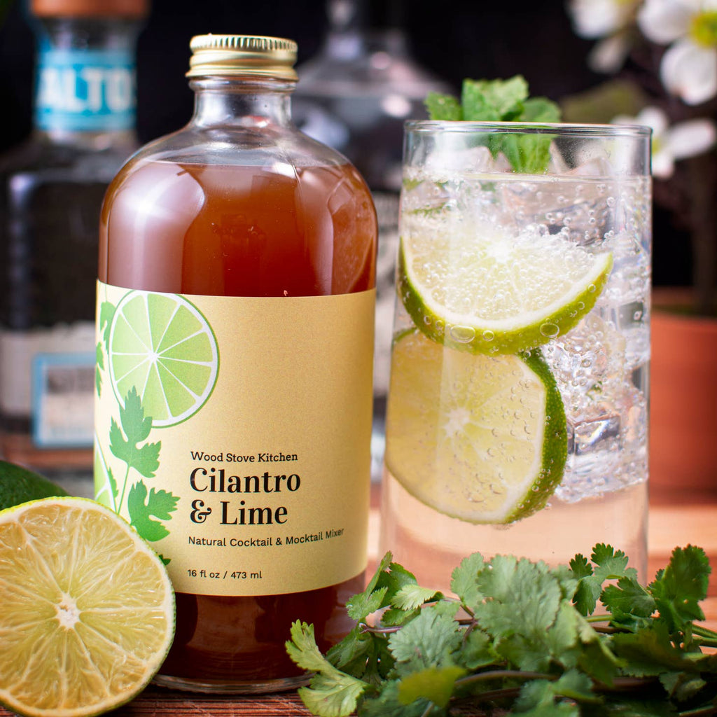 Glass bottle with brown liquid encompassing the flavors of cilantro and lime. Label on bottle with images of lime wedges and cilantro leaves.