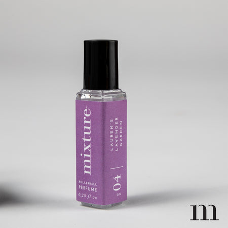 Small rectangular glass bottle with black lid. Purple liquid with white text saying, “Mixture Eau de Parfum”.
