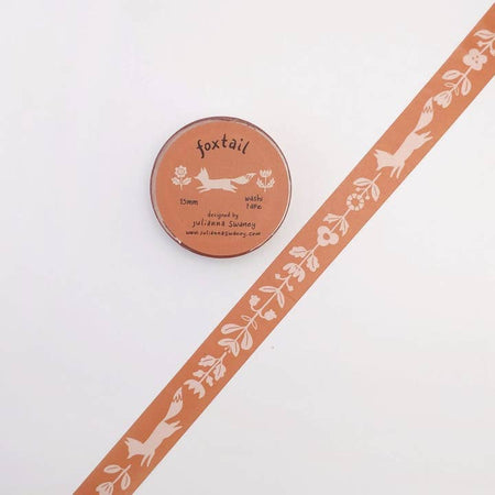 Pink washi tape with repeating images of white floral garland and white foxes.