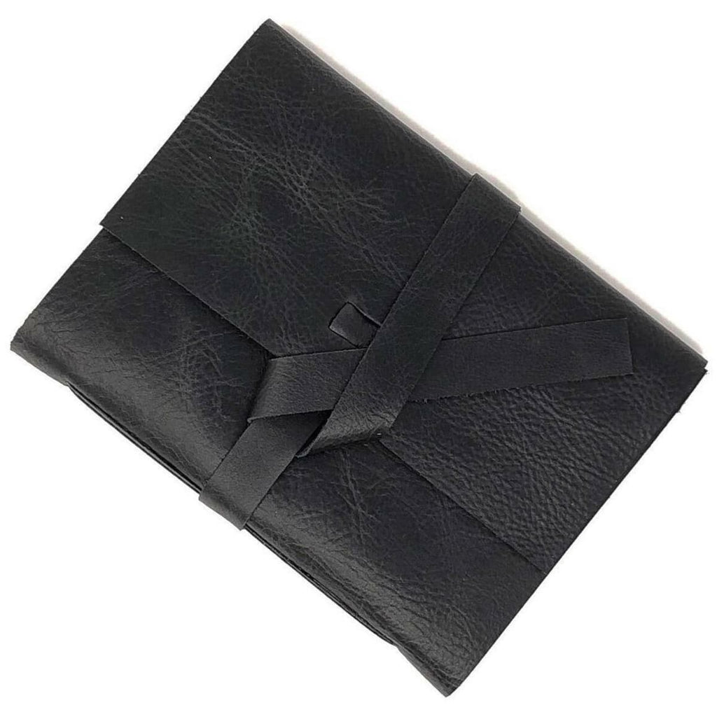 Black leather cover with two straps that tie together to close notebook.