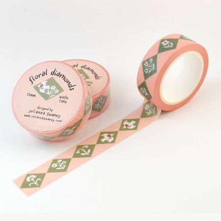 Pink washi tape with repeating images of green diamond shapes with white flowers and white birds in center.