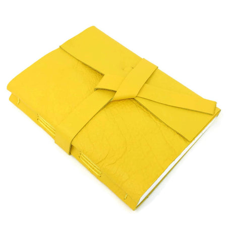 Cheerful Yellow soft leather cover with two leather straps crossed in the middle.