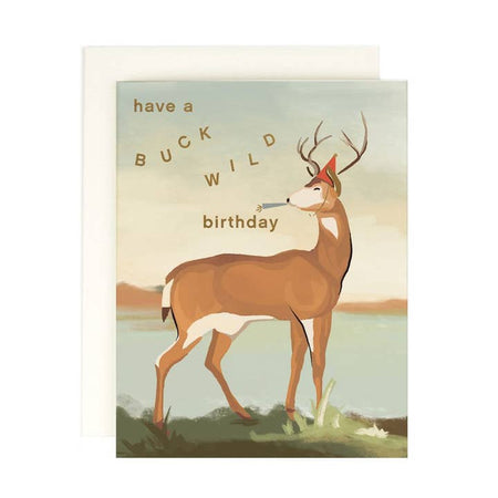 Birthday card with a deer illustration and text 'have a buck wild birthday' on a scenic background. A white envelope is included.