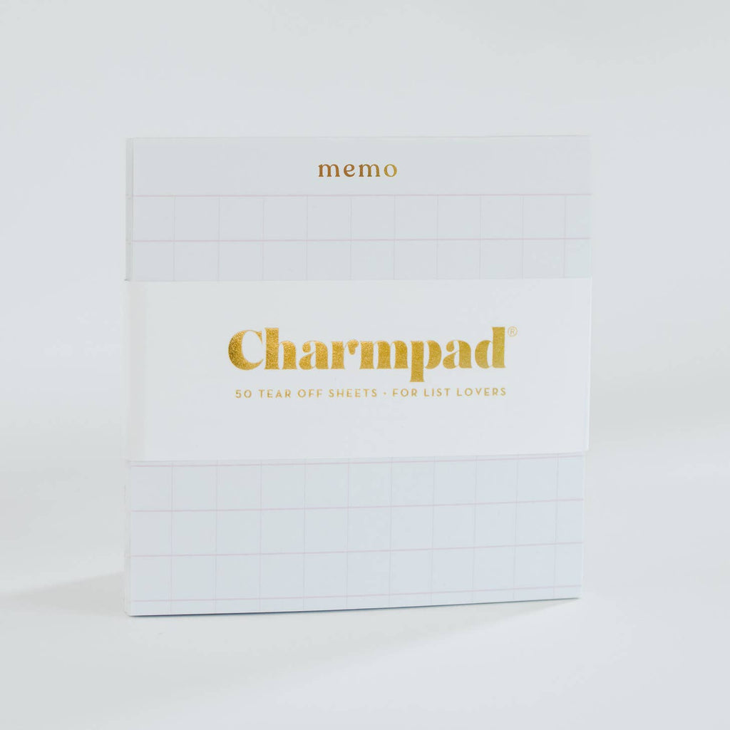White square notepad with gold foil text saying, “Memo” in top center.