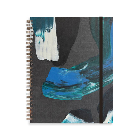 Notebook with black cover with black, blue, white and green brushstroke abstract pattern. Metal coil binding on left side. Black elastic over right side.