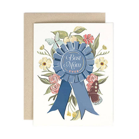 Ivory card with image of a blue first place ribbon saying, “Best Mom Ever”. Images of various flowers surrounding the ribbon. An ivory envelope is included.