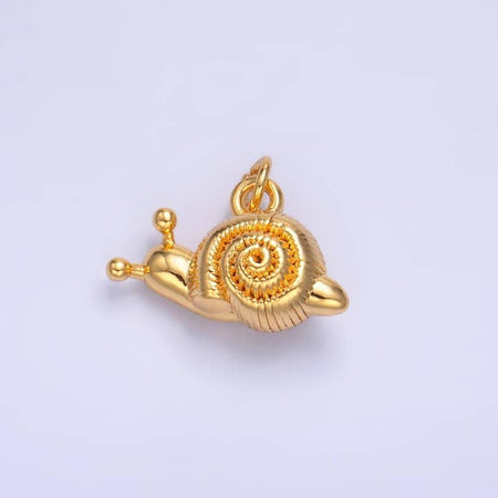 Gold charm in the image of a snail.