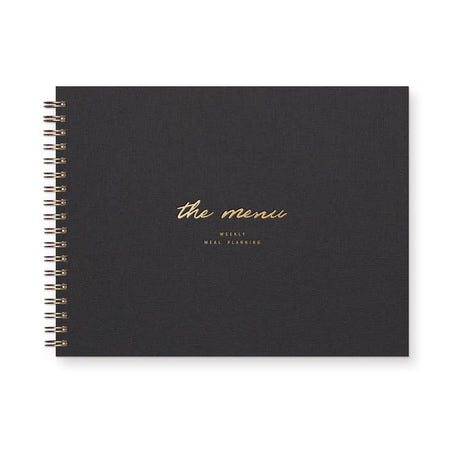Notebook with black linen cover with gold foil text saying, 