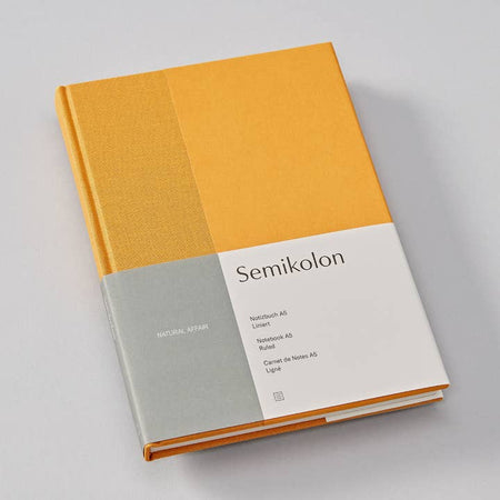 Hardcover journal with two toned yellow cover. Darker yellow strip on left side.