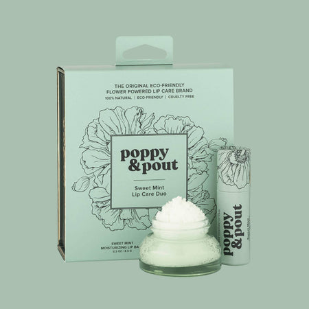 Gift set in a mint green square box with black text saying, “Poppy & Pout Sweet Mint Lip Care Duo”. Includes a green lip balm tube with black text and black outlined poppy flowers; small plastic container with white lid and green lip scrub inside.