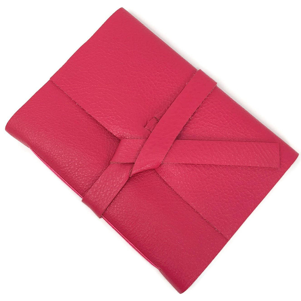 Pink soft leather cover with two leather straps crossed in the middle.