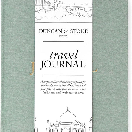   Sage green color journal with gold foil text saying, “Travel Journal” in center.