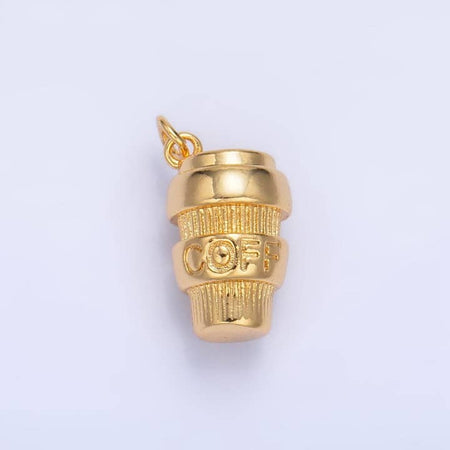 Gold charm in the image of a coffee tumbler cup with “COFFEE” written around the cup.