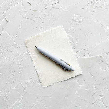 Light blue pen on textured white background. 