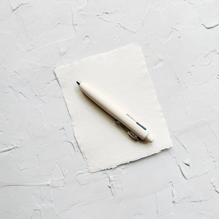 Cream colored pen on white paper